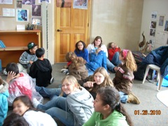 Students sitting on the floor. 